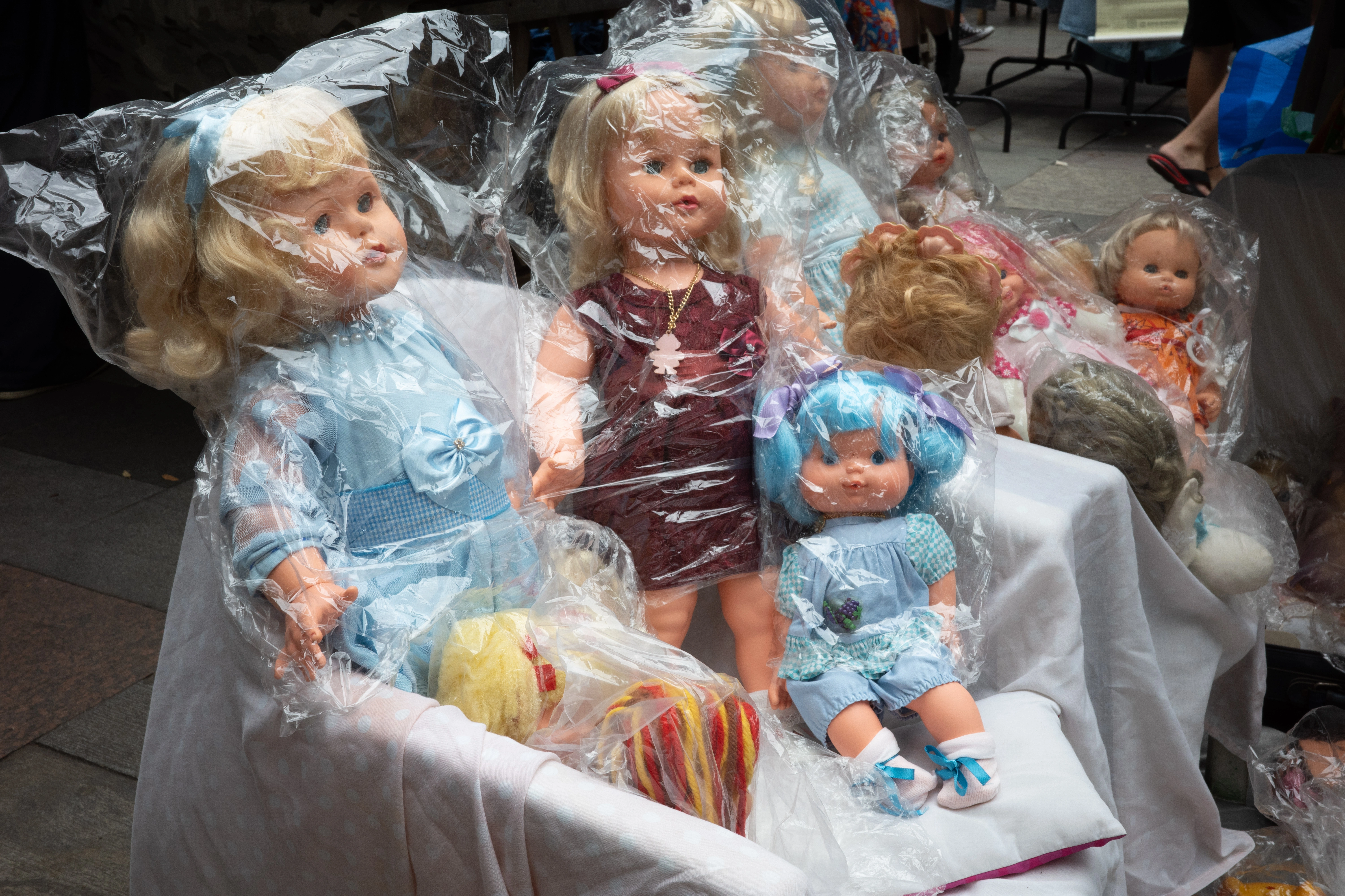 Traditional dolls lined up on a street market