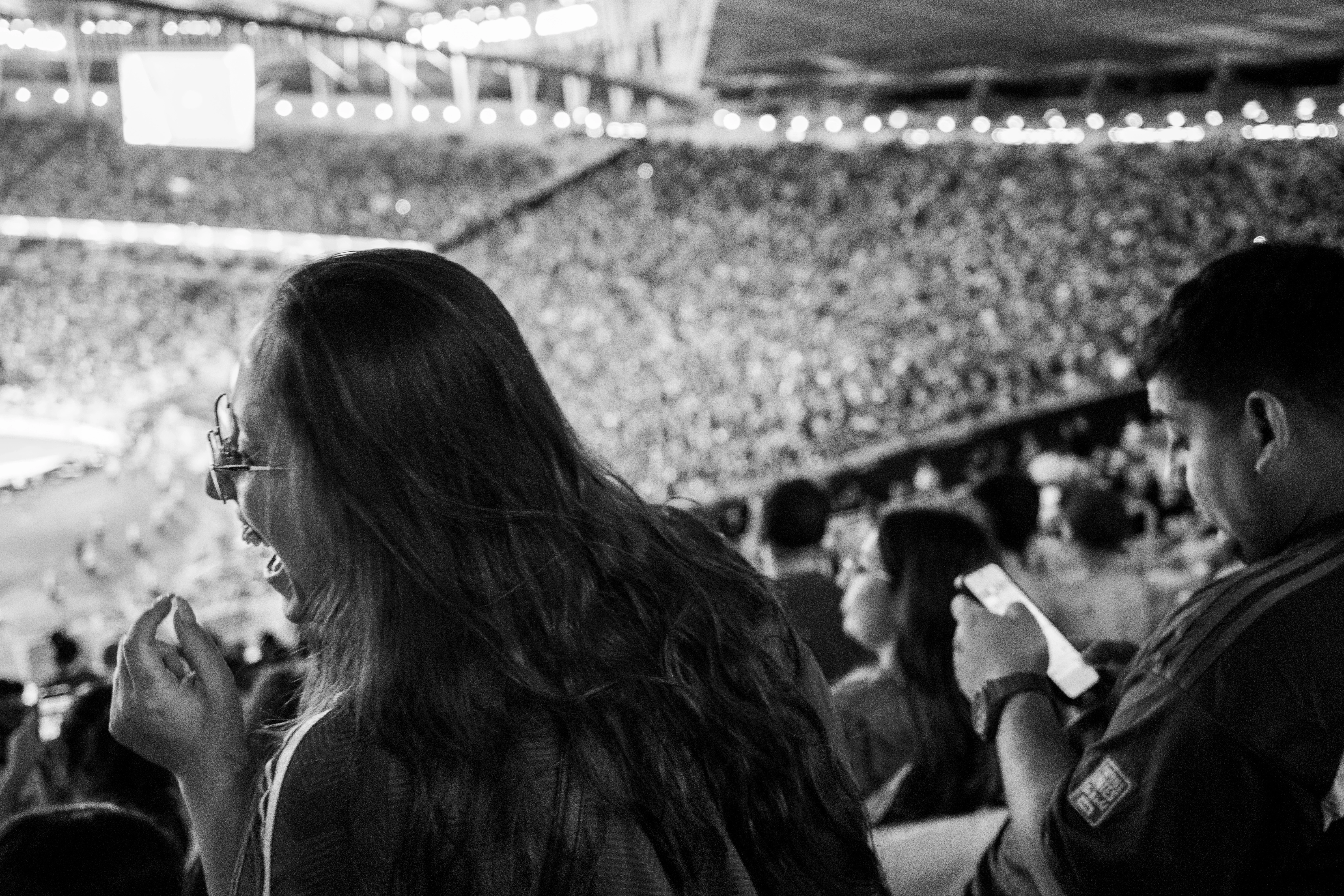 Fans at Maracanã during a packed match, black and white